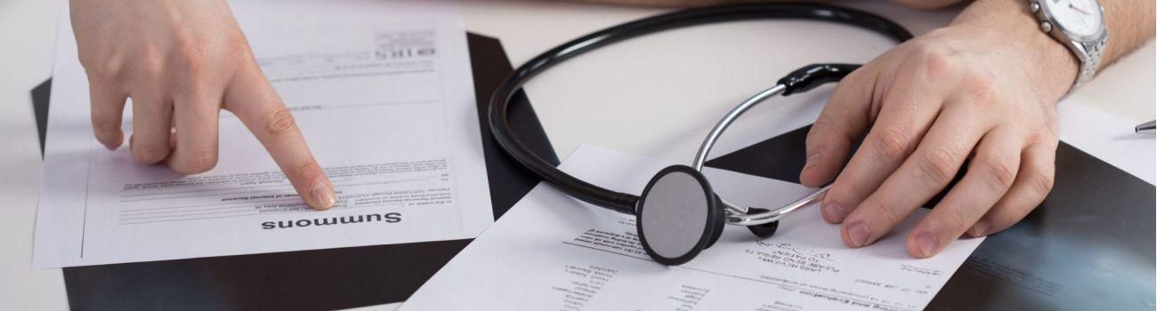38738428 - summons paper on the table in doctor's office