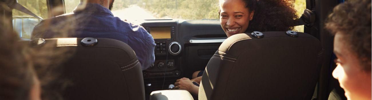 71404568 - excited family on a road trip in car, rear passenger pov